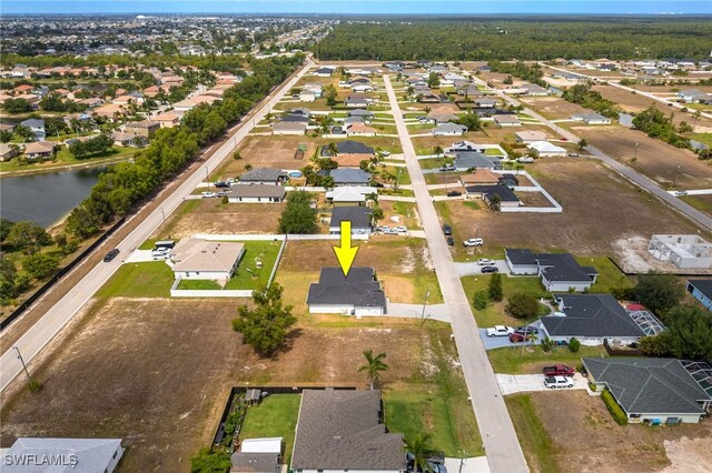 aerial view of property's location with nearby suburban area and a large body of water