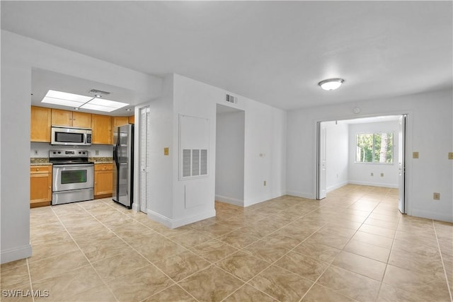 3160 Seasons Way Unit 709, Estero, FL 33928 - kitchen with stainless steel appliances, light tile patterned floors, and visible vents
