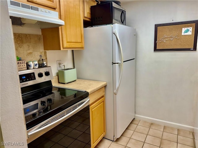 3706 Broadway Unit 18, Fort Myers, FL 33901 - kitchen featuring stainless steel range with electric cooktop, under cabinet range hood, light countertops, light tile patterned floors, and light brown cabinets