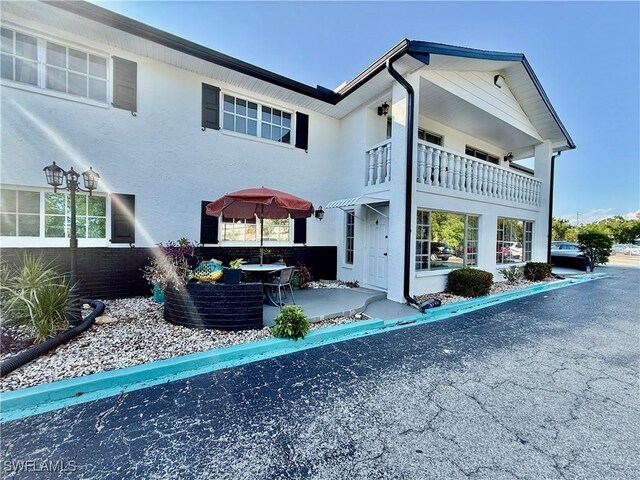 3706 Broadway Unit 18, Fort Myers, FL 33901 - back of house with stucco siding, a balcony, and a patio area