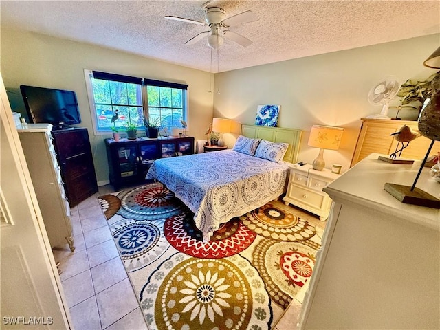 3706 Broadway Unit 18, Fort Myers, FL 33901 - bedroom with light tile patterned floors, a textured ceiling, and ceiling fan
