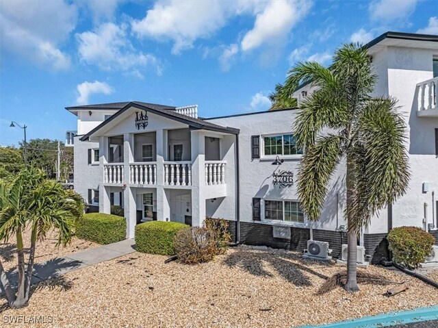 3706 Broadway Unit 18, Fort Myers, FL 33901 - view of front of home featuring stucco siding, a balcony, and a cooling unit