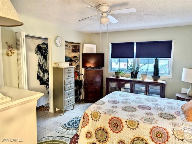 3706 Broadway Unit 18, Fort Myers, FL 33901 - bedroom with light tile patterned floors, a textured ceiling, and ceiling fan