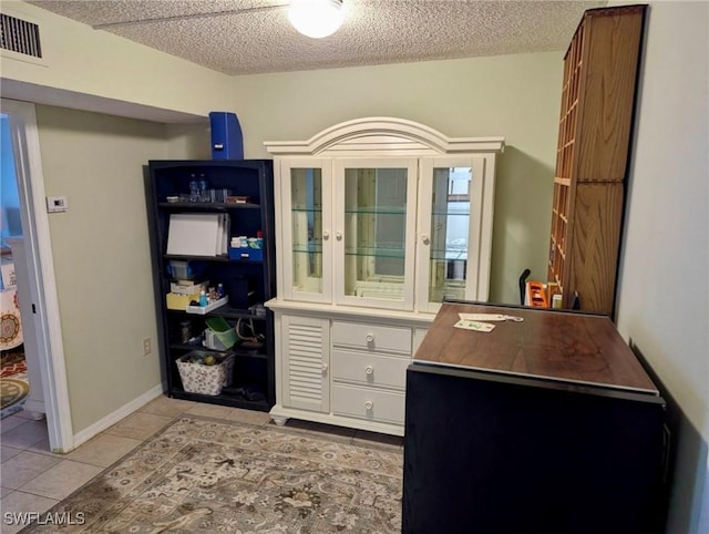 3706 Broadway Unit 18, Fort Myers, FL 33901 - home office featuring light tile patterned flooring and a textured ceiling