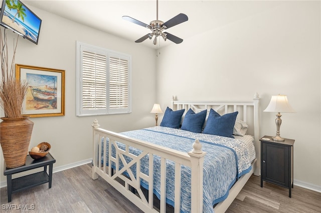 bedroom with wood finished floors, baseboards, and a ceiling fan