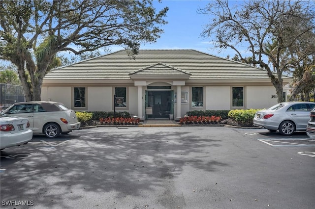 3435 Laurel Greens Ln S Unit 202, Naples, FL 34119 - view of building exterior featuring uncovered parking