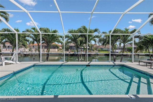swimming pool with a water view, a patio area, and glass enclosure