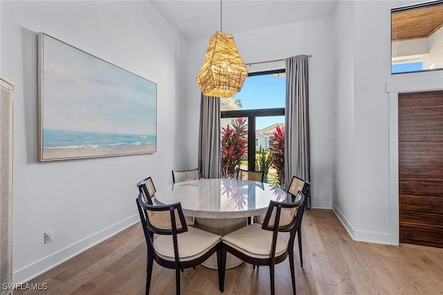 dining space with wood finished floors and baseboards