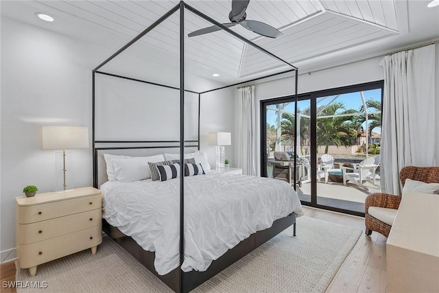 bedroom featuring access to outside, wood finished floors, and recessed lighting