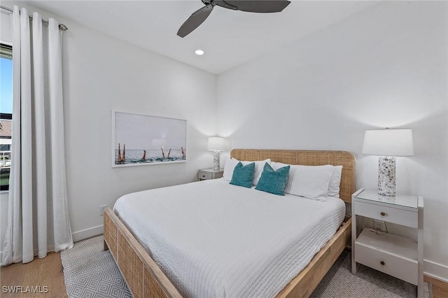 bedroom featuring wood finished floors, baseboards, recessed lighting, and a ceiling fan