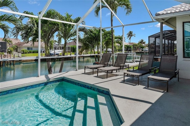 swimming pool with a water view, a patio, and glass enclosure