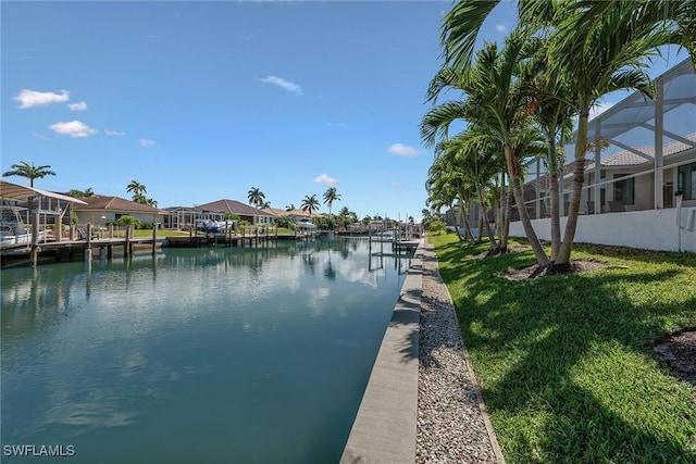 water view featuring a dock and nearby suburban area
