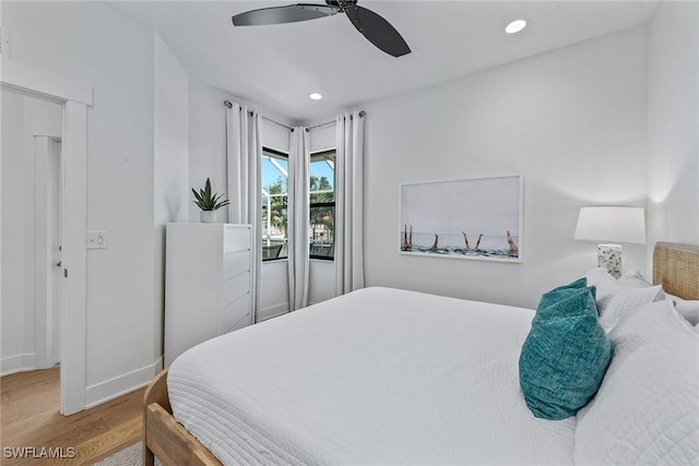bedroom featuring wood finished floors, recessed lighting, baseboards, and ceiling fan