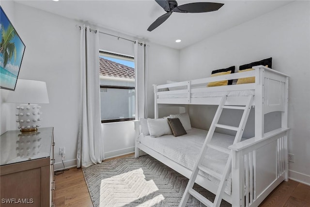 bedroom with wood finished floors, recessed lighting, baseboards, and ceiling fan