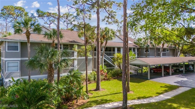 622 Wiggins Bay Dr Unit C-22, Naples, FL 34110 - view of building exterior with covered parking