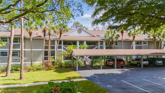 622 Wiggins Bay Dr Unit C-22, Naples, FL 34110 - view of building exterior with covered parking and stairway