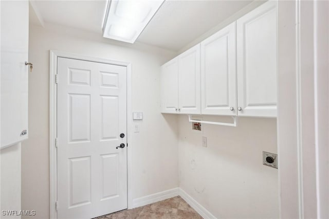laundry room with electric dryer hookup, cabinet space, baseboards, and hookup for a washing machine