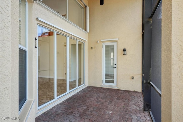 property entrance featuring stucco siding and a patio area