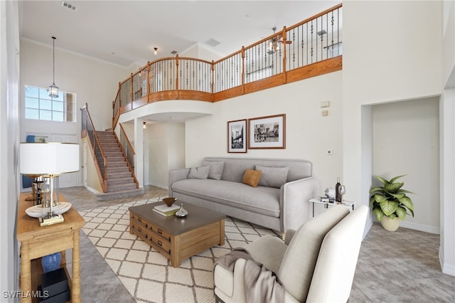 living room with a high ceiling, baseboards, stairway, and arched walkways