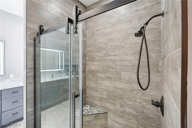 full bathroom with a shower stall and vanity