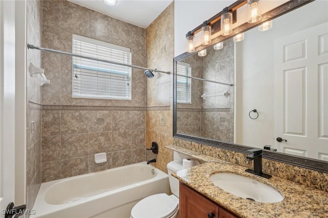 bathroom with toilet, vanity, and washtub / shower combination