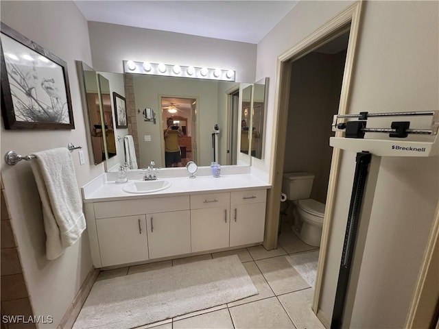 full bathroom featuring tile patterned flooring, a ceiling fan, toilet, and vanity