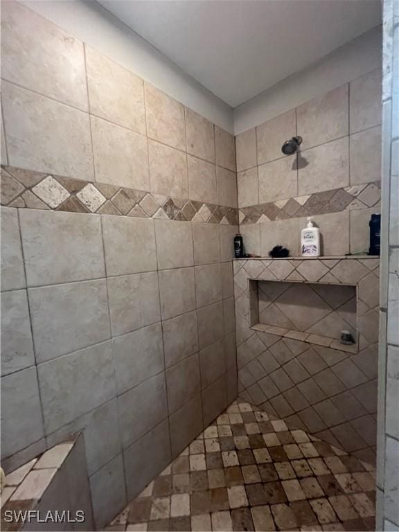 bathroom with a tile shower