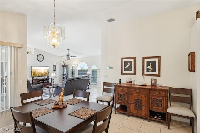 dining space with light tile patterned floors, a chandelier, a ceiling fan, and lofted ceiling