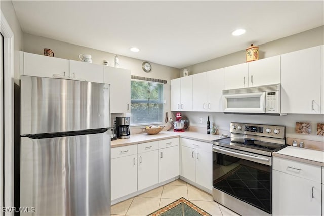kitchen with stainless steel appliances, light tile patterned flooring, light countertops, white cabinets, and recessed lighting