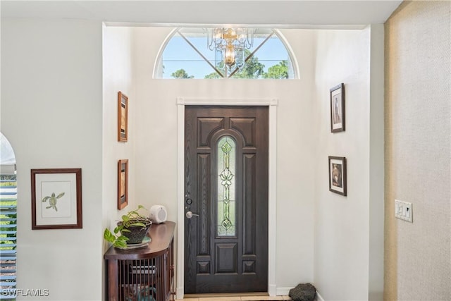 foyer entrance with a chandelier