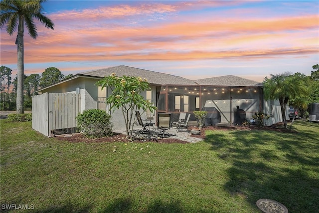 rear view of house with a yard and a patio