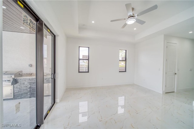 710 SW 25th Ln, Cape Coral, FL 33914 - empty room with a raised ceiling, recessed lighting, a ceiling fan, baseboards, and marble tiled floors