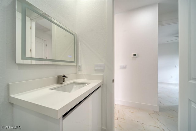 710 SW 25th Ln, Cape Coral, FL 33914 - bathroom with marble finish flooring, baseboards, and vanity