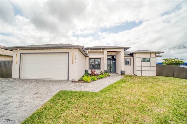 710 SW 25th Ln, Cape Coral, FL 33914 - prairie-style home with a garage, stucco siding, and decorative driveway