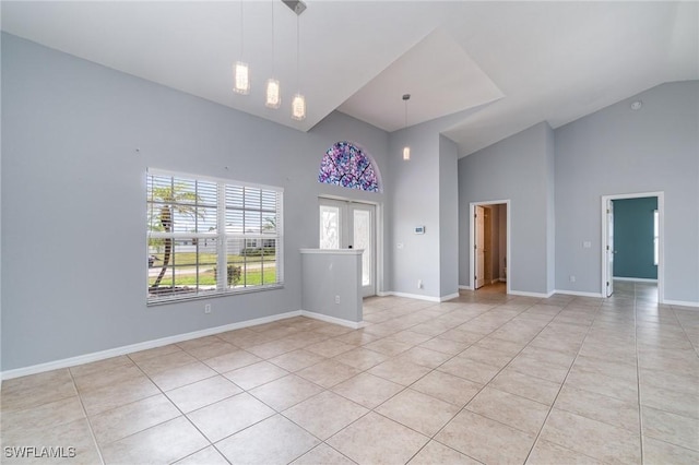 3113 SW 22nd Pl, Cape Coral, FL 33914 - unfurnished living room featuring light tile patterned floors, high vaulted ceiling, and baseboards