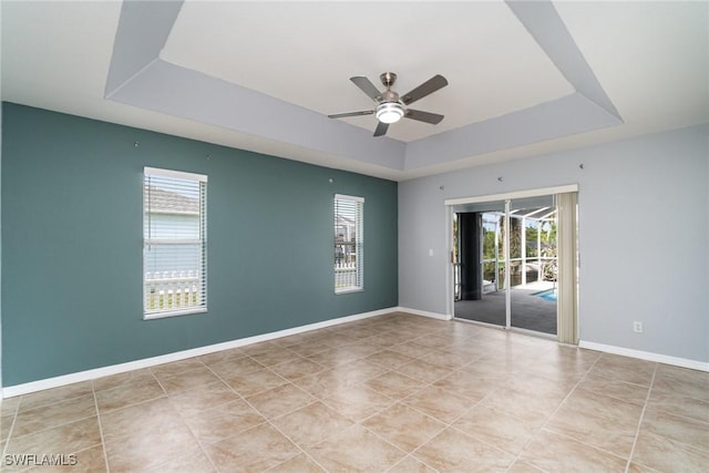 3113 SW 22nd Pl, Cape Coral, FL 33914 - tiled spare room featuring a tray ceiling, ceiling fan, and baseboards