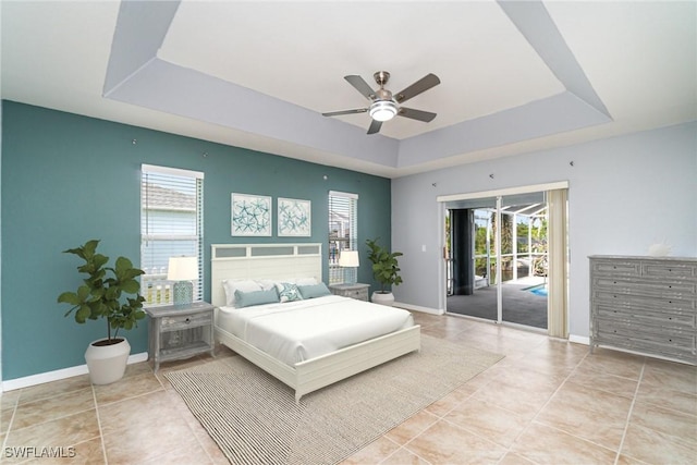 3113 SW 22nd Pl, Cape Coral, FL 33914 - bedroom with a tray ceiling, access to outside, light tile patterned floors, and baseboards