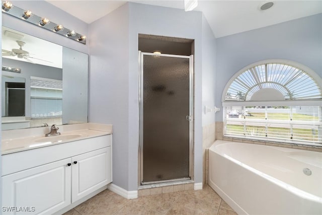 3113 SW 22nd Pl, Cape Coral, FL 33914 - bathroom with a stall shower, a garden tub, vanity, tile patterned floors, and baseboards