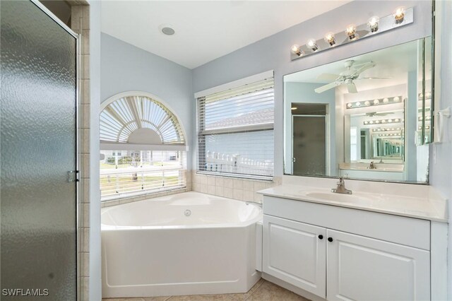 3113 SW 22nd Pl, Cape Coral, FL 33914 - full bath with a stall shower, a ceiling fan, a bath, vanity, and tile patterned floors