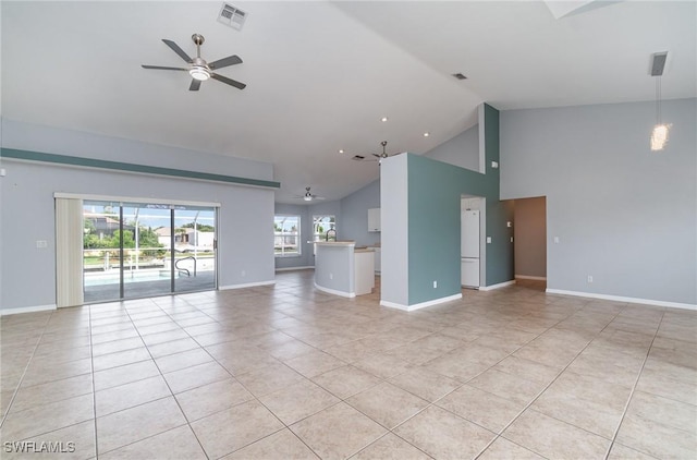 3113 SW 22nd Pl, Cape Coral, FL 33914 - unfurnished living room with a ceiling fan, light tile patterned floors, high vaulted ceiling, and baseboards