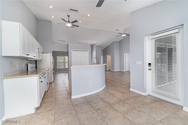 3113 SW 22nd Pl, Cape Coral, FL 33914 - kitchen featuring ceiling fan, light tile patterned floors, light countertops, white cabinetry, and high vaulted ceiling