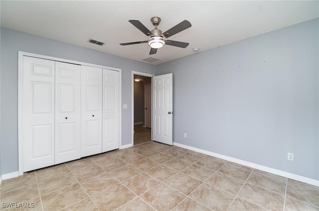 3113 SW 22nd Pl, Cape Coral, FL 33914 - unfurnished bedroom with a closet, baseboards, light tile patterned flooring, and a ceiling fan