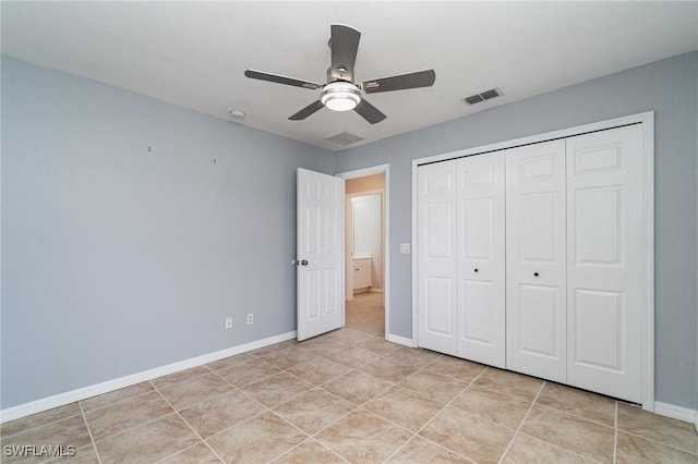 3113 SW 22nd Pl, Cape Coral, FL 33914 - unfurnished bedroom featuring baseboards, light tile patterned flooring, a closet, and a ceiling fan