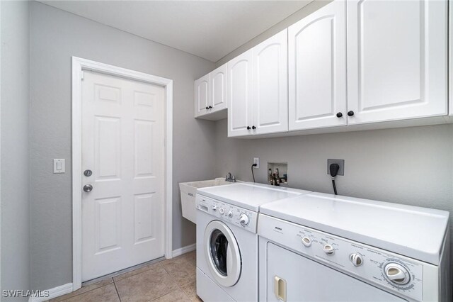 3113 SW 22nd Pl, Cape Coral, FL 33914 - washroom featuring cabinet space, washer and clothes dryer, baseboards, and light tile patterned flooring