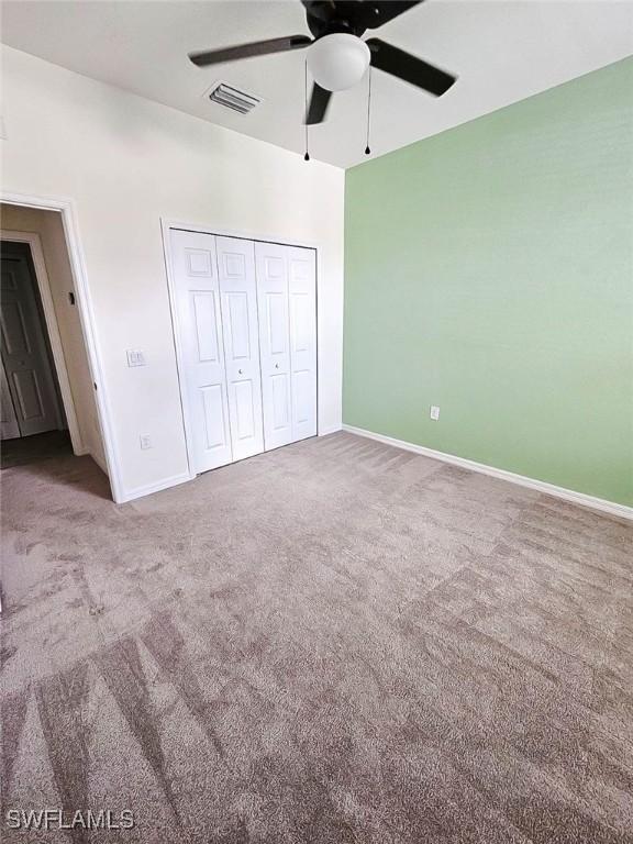 2685 Citrus St, Naples, FL 34120 - unfurnished bedroom featuring baseboards, carpet flooring, a closet, and visible vents
