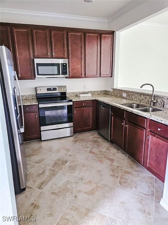 2685 Citrus St, Naples, FL 34120 - kitchen featuring dark brown cabinets, ornamental molding, stainless steel appliances, and a sink