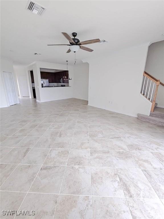 2685 Citrus St, Naples, FL 34120 - unfurnished living room with light tile patterned floors, a ceiling fan, and visible vents