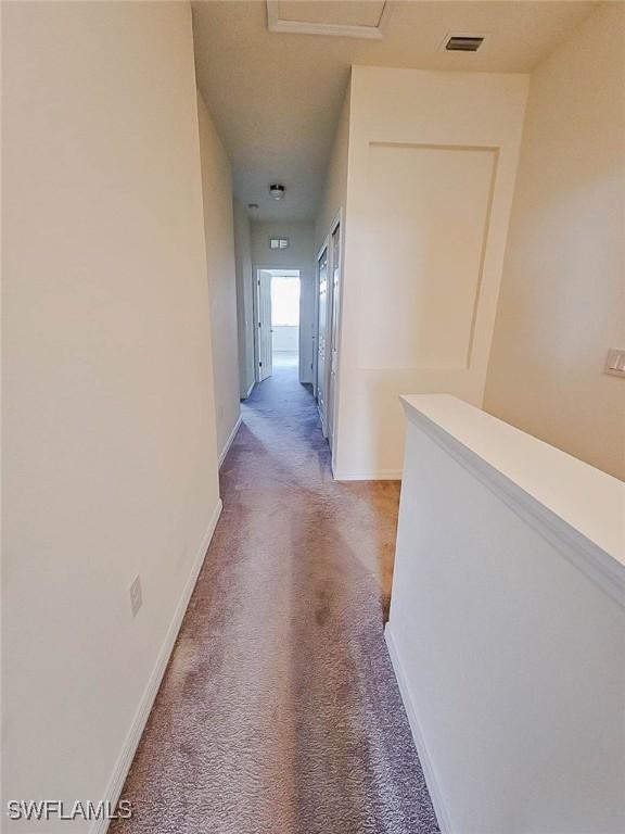 2685 Citrus St, Naples, FL 34120 - hall with light colored carpet, baseboards, and visible vents