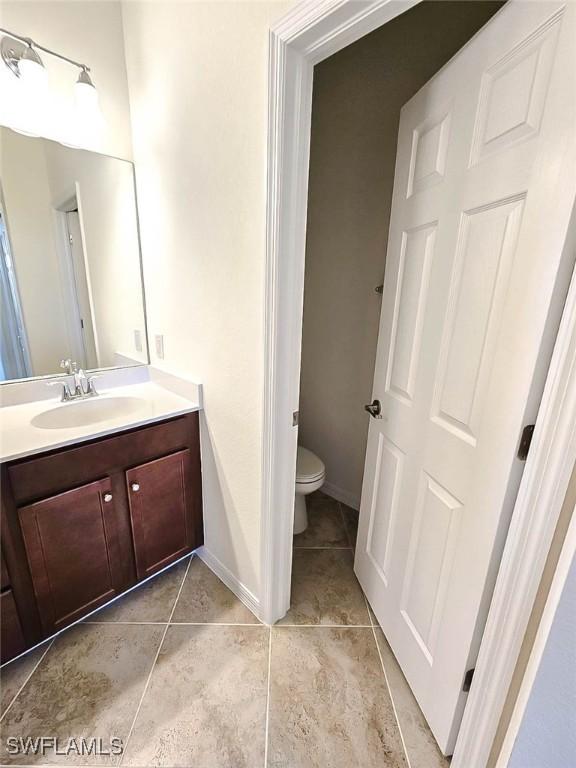 2685 Citrus St, Naples, FL 34120 - bathroom featuring toilet, baseboards, tile patterned flooring, and vanity