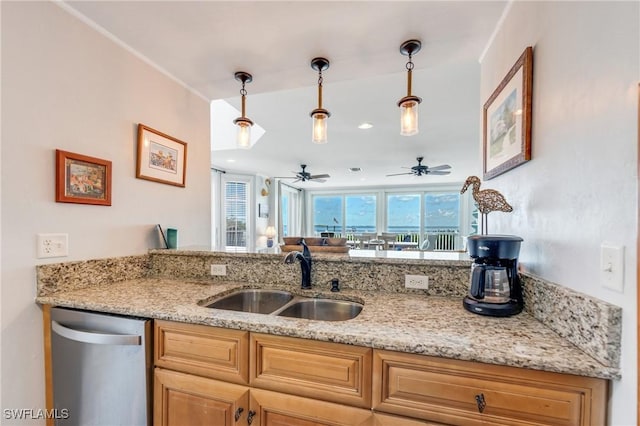 kitchen featuring a sink, stainless steel dishwasher, pendant lighting, and a ceiling fan